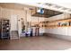 Well-organized garage featuring epoxy flooring, storage shelves, and an overhead storage rack at 30 Stewart Way, Erie, CO 80516