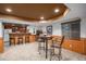 Finished basement area featuring a wet bar, wine cooler, and seating area perfect for entertaining guests at 1250 Oneida St, Denver, CO 80220