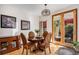 Dining room featuring stylish light fixture, hardwood floors, and doors to the outdoor at 1250 Oneida St, Denver, CO 80220