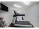 Home fitness area with treadmill and weights, providing convenience for exercise routines at 1250 Oneida St, Denver, CO 80220