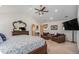 Large bedroom with sitting area, vaulted ceiling, and detailed wood furnishings at 1250 Oneida St, Denver, CO 80220