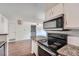 Modern kitchen with black appliances, granite countertops and ample cabinet space at 922 S Walden Street St # 103, Aurora, CO 80017