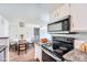 Well-equipped kitchen with modern appliances and granite countertops, laundry room nearby at 922 S Walden Street St # 103, Aurora, CO 80017