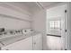 Laundry room with washer and dryer and storage shelving at 922 S Walden Street St # 103, Aurora, CO 80017