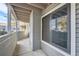 Cozy covered patio featuring neutral siding and a large window showcasing the outdoor surroundings at 922 S Walden Street St # 103, Aurora, CO 80017