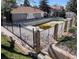 Community pool area, bordered by decorative stone and fencing. Note that the pool is empty for maintenance at 922 S Walden Street St # 103, Aurora, CO 80017