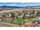 Aerial view of the property surrounded by green fields and mountains, outlining property boundaries at 5855 Rustic Knolls Dr, Boulder, CO 80301