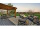 Outdoor deck area with pergola, dining table, sofa and firepit, perfect for entertaining or relaxing at 5855 Rustic Knolls Dr, Boulder, CO 80301