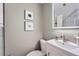 Modern half bathroom with white vanity, sleek faucet, illuminated mirror, and neutral wall color at 5855 Rustic Knolls Dr, Boulder, CO 80301