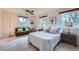 Bright bedroom featuring a cozy sitting area and a comfortable bed with decorative pillows at 5855 Rustic Knolls Dr, Boulder, CO 80301