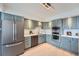 Contemporary kitchen featuring blue cabinets, stainless steel appliances, and ample counter space at 5855 Rustic Knolls Dr, Boulder, CO 80301