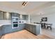 Stylish kitchen with ample storage, gray cabinets, stainless steel appliances, and quartz counter tops at 5855 Rustic Knolls Dr, Boulder, CO 80301