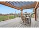 Outdoor patio with a dining table, comfortable seating, and a pergola overlooking a grassy lawn at 5855 Rustic Knolls Dr, Boulder, CO 80301