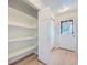 Walk-in pantry with ample shelving, and a door providing access to the exterior of the house at 5855 Rustic Knolls Dr, Boulder, CO 80301