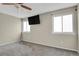 Comfortable bedroom with neutral colors, plush carpet, and mounted TV at 3844 S Gibralter St, Aurora, CO 80013