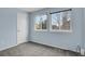 Light blue bedroom featuring two windows and neutral color carpet at 3844 S Gibralter St, Aurora, CO 80013