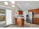 Well-lit kitchen features stainless steel appliances, wood cabinets, and a breakfast bar at 3844 S Gibralter St, Aurora, CO 80013