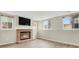 Cozy living room with a brick fireplace and a mounted television at 3844 S Gibralter St, Aurora, CO 80013