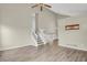 Inviting living room with staircase and neutral paint, featuring stylish wood-look flooring at 3844 S Gibralter St, Aurora, CO 80013