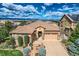 An aerial view of a house with a large yard, two-car garage, and mountain views at 10443 Skyreach Way, Highlands Ranch, CO 80126