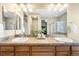 Bathroom with double vanity and large mirror at 10443 Skyreach Way, Highlands Ranch, CO 80126