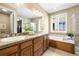 Elegant bathroom with double vanity and soaking tub at 10443 Skyreach Way, Highlands Ranch, CO 80126