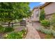 Landscaped side yard with brick path and mature trees at 10443 Skyreach Way, Highlands Ranch, CO 80126