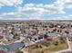 This is a high-angle view of a home with solar panels located in a neighborhood with sidewalks and mature trees at 14642 Sorrel Dr, Broomfield, CO 80023