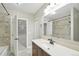 Bathroom featuring a vanity with a dark wood cabinet and a tiled shower at 14642 Sorrel Dr, Broomfield, CO 80023