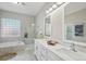 Well-lit bathroom with double sinks, tile flooring, a separate shower, and a soaking tub at 14642 Sorrel Dr, Broomfield, CO 80023