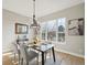 Sunlit dining room with hardwood floors, chandelier, and large window at 14642 Sorrel Dr, Broomfield, CO 80023