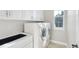 Functional laundry room featuring modern appliances, cabinetry, and a utility sink at 14642 Sorrel Dr, Broomfield, CO 80023