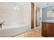 Bright bathroom features a modern tub and shower with elegant tile, lighting, and wood accents at 1630 N Clarkson St # 110, Denver, CO 80218