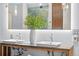 Bathroom featuring a double sink vanity with modern faucets, lighting, and an oversized mirror at 1630 N Clarkson St # 110, Denver, CO 80218