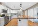 Bright kitchen featuring a kitchen island with a wooden bar top, stainless steel appliances, and modern white cabinets at 1630 N Clarkson St # 110, Denver, CO 80218