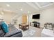 Finished basement offering a spacious entertainment area with a plush couch and entertainment system at 7902 E 49Th Pl, Denver, CO 80238