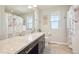 Bright bathroom with granite counters, dark cabinets, and light wood-look floors and an owl-themed shower curtain at 7902 E 49Th Pl, Denver, CO 80238