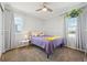 Comfortable bedroom with natural light, a ceiling fan, and charming decor including a houseplant at 7902 E 49Th Pl, Denver, CO 80238