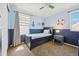 Charming bedroom in nautical theme, including dark blue wainscoting and ship-themed decor at 7902 E 49Th Pl, Denver, CO 80238