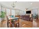 Bright dining area with hardwood floors, a chandelier, and large windows overlooking the backyard at 7902 E 49Th Pl, Denver, CO 80238