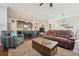 Cozy living room featuring a leather sofa, patterned armchair, and an open layout to the kitchen at 7902 E 49Th Pl, Denver, CO 80238