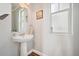 Clean powder room featuring a pedestal sink, updated fixtures, and a bright, airy feel at 7902 E 49Th Pl, Denver, CO 80238