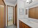 The well-lit bathroom has a vanity with a white sink and a doorway to the toilet and shower at 8378 S Upham Way # B205, Littleton, CO 80128