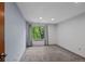 This carpeted bedroom has a window with gray curtains and natural light at 8378 S Upham Way # B205, Littleton, CO 80128
