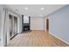 Spacious living area featuring hardwood floors, fireplace, and sliding door to balcony at 8378 S Upham Way # B205, Littleton, CO 80128