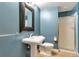 Clean bathroom with pedestal sink, toilet, and shower at 290 W 12Th Ave # 401, Denver, CO 80204