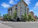 Modern multi-unit building in urban setting with tree-lined street at 290 W 12Th Ave # 401, Denver, CO 80204