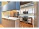 Modern kitchen with stainless steel appliances and wood cabinets at 290 W 12Th Ave # 401, Denver, CO 80204