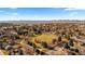 Vast aerial view of the community featuring a large park, mature trees, and residential homes in a serene setting at 3663 S Sheridan Blvd # I8, Denver, CO 80235