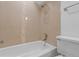 Clean bathroom with neutral tile and updated shower/tub at 3663 S Sheridan Blvd # I8, Denver, CO 80235